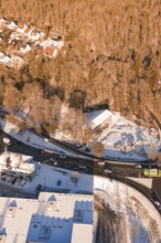 Snowy road junction on the edge of a forest with adjacent buildings, Nagold, Calw district, Black