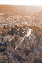Bird's-eye view of snowy castle surrounded by forest and city, Nagold, Calw district, Black Forest,