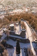 Snowy castle with two towers and city in the background, wintery atmosphere, Nagold, Calw district,