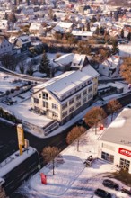 Building at a snowy crossroads in a town, Nagold, Calw district, Black Forest, Germany