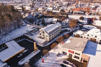 Building and gas station in a snowy urban landscape, Nagold, Calw district, Black Forest, Germany