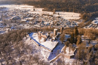 Snowy castle surrounded by trees overlooking a town in winter, Nagold, Calw district, Black Forest,