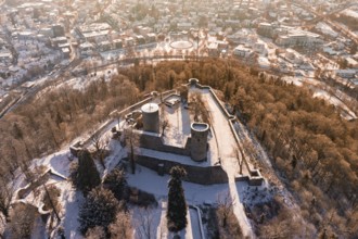 Panoramic view of a snowy castle with city in the background, surrounded by trees, Nagold, Calw