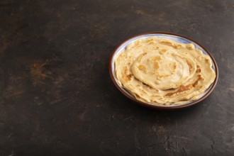 Stack of Plain Fried pancakes on black concrete background. side view, copy space