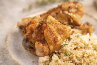 Fried Turkey Wing with spices and rice on brown concrete background and linen textile. side view,