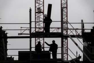 Construction site, scaffolding work on a large construction project, apartments and commercial