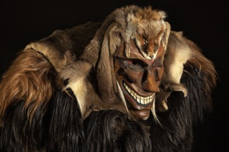 Portrait of traditional hand-carved wooden mask from the Loetschental Carnival, representing