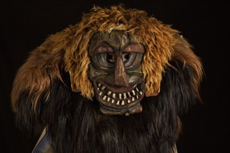 Portrait of traditional hand-carved wooden mask from the Loetschental Carnival, representing