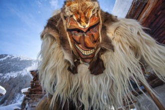 Portrait of traditional hand-carved wooden mask from the Loetschental Carnival, representing