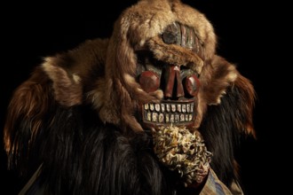Portrait of traditional hand-carved wooden mask from the Loetschental Carnival, representing