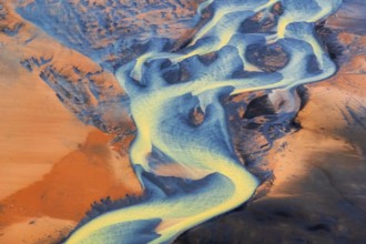 Aerial view of the colorful Þjórsá River, Iceland's longest river, weaving through volcanic
