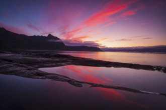 Coastal view in Senja, Norwegian Sea, rugged cliffs and mountains composed mainly of Precambrian