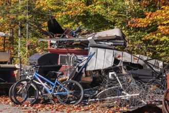 Pile of discarded metal objects including bicycles, sheet metal cladding, pipes, steel wire waiting