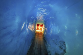 Ice cave, Swiss flag in the ice cave, Tourists attraction, Rhone glacier, Furka pass, Obergoms,