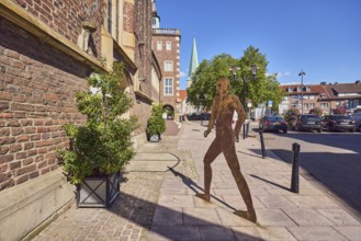 Brick building, façade, historic town hall, masonry, sculpture of a person silhouette, barrier