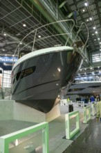 Press photo View of elegant bow of luxury yacht luxurious Sunseeker motor yacht in exhibition hall