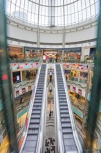 Symmetrical escalators in a spacious and bright shopping center, London, England, Great Britain