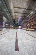 A spacious, minimalistic lobby with marble floors and modern furniture, London, England, United