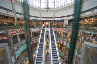 Large shopping center with multiple levels of shops and escalators, London, England, United Kingdom