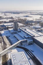 Detailed aerial view of a snow-covered factory site with a distinctive tower, Häfele, Nagold,