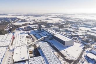 Long-range aerial view of a snow-covered industrial area with clear contours and blue sky, Häfele,