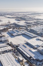 Snow-covered industrial area with a variety of buildings under clear skies, Wolfsberg industrial