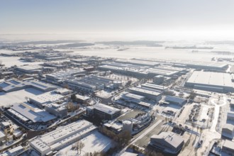 Aerial view of an industrial area in winter with snowy roofs and clear sky, Wolfsberg industrial