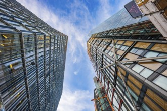 Two modern buildings reflected in the urban sky, London, England, Great Britain