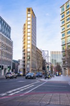 An urban street scene with modern buildings and moving cars, London, England, Great Britain