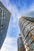 View between two modern skyscrapers in the blue sky, London, England, Great Britain