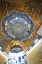 Brick vault with artistic ceiling motif and lettering in a modern urban space, London, United