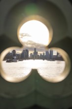 Looking through an opening shows an urban landscape with modern buildings at sunset, London, United