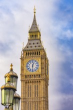 Close-up of a clock tower with gothic architecture against a blue sky, Big Ben, London, United