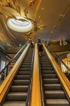 Escalator and ornate ceiling light in Iconsiam shopping center, Bangkok, Thailand's metropolis,
