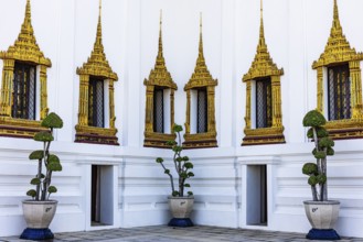The Grand Royal Palace, richly decorated and gilded windows at the Dusit Maha Prasad throne hall,