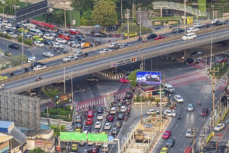 Busy road intersection with the Thai-Belgian Bridge, view from the Moon Bar on the roof terrace of