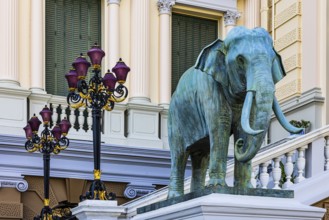 The Grand Royal Palace, an elephant statue and multi-armed lanterns decorate the side entrance of