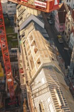 Close-up of construction work on a roof with workers in an urban environment, carpentry,
