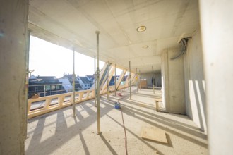 Sunny interior of a construction site with supports and wooden frame, carpentry, renovation, roof