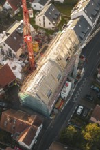 Detailed view of a construction site in a residential area with a crane from above, carpentry,