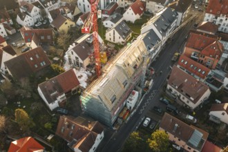 Aerial view of a construction site using cranes and roof work in an urban environment, carpentry,