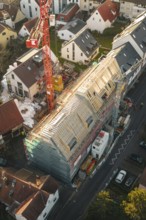 Overview of a large construction site in a residential area during roof renovation, carpentry,