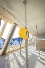 Shell with wooden roof racks and construction site safety equipment indoors, carpentry, renovation,