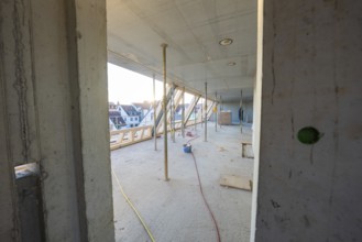 Semi-finished interior of a construction site with exposed structure and supports, carpentry