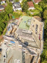Aerial view of a construction site in a residential area with progressive building construction,