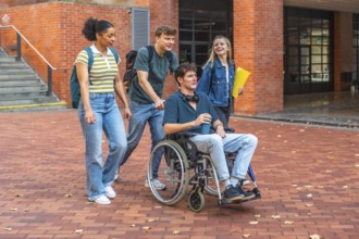 Young adult students walking and chatting on campus, diverse group including a male student in a
