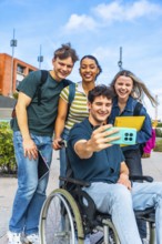 Group of happy diverse university students, including a person using a wheelchair, smiling and