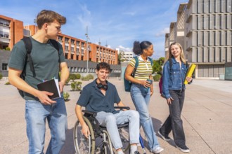 Diverse group of young students experiencing inclusion while walking and talking on a university