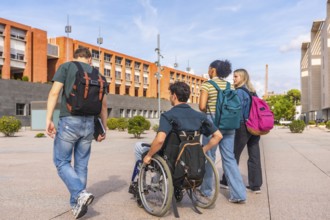 Diverse group of young students, including one in a wheelchair, carrying backpacks and walking