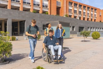 Multi ethnic group of university students, including a wheelchair user, walking and chatting on